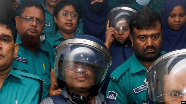 Journalists Shakil Ahmed, fifth from the left, and Farzana Rupa, third from the right, are taken to a court in Dhaka, Bangladesh, on Aug. 22, 2024.