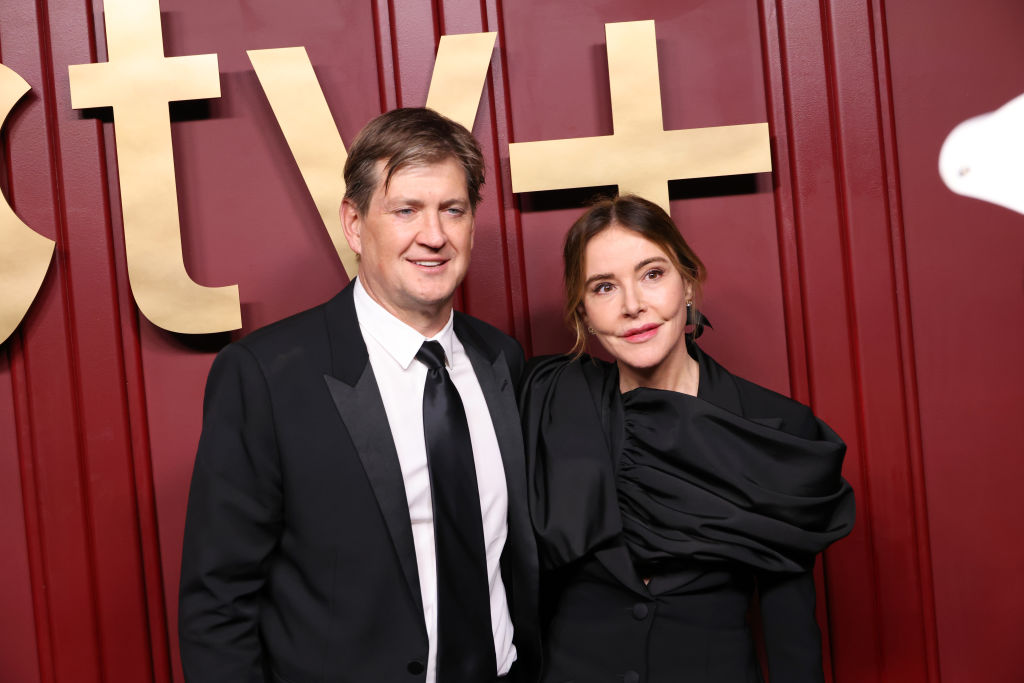 Bill Lawrence and Christa Miller dressed in black smiling at an event